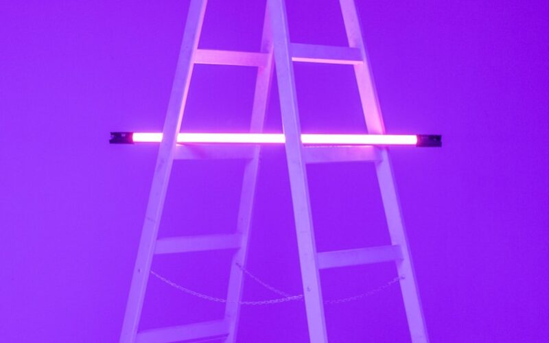 turned-on fluorescent lamp on folding ladder